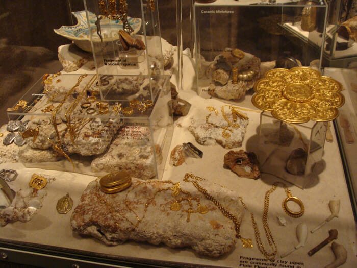 Caption 7- Jewels fit for a Queen along with other gold artifacts are artfully arranged in this case. 