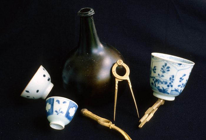 Caption 19- Porcelain cups, onion bottle and bronze navigational divider. -1715 Fleet