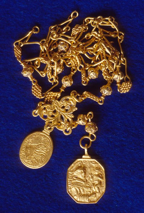 Caption 24- Gold religious medallions on a gold Rosary chain. Note that the medallion on the right is St. Christopher carrying the baby Jesus. -1715 Fleet