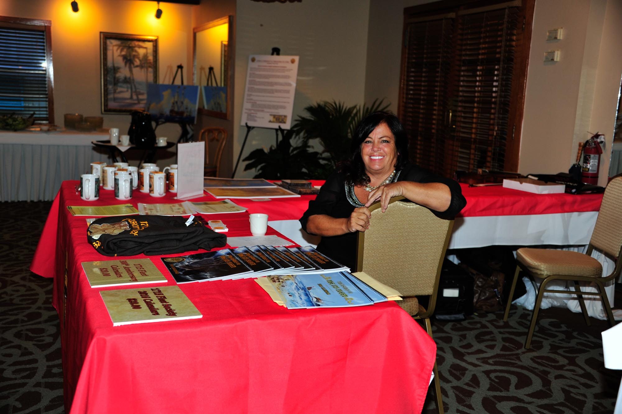 Robin Miller, Ambassador at Captain Hiram's Resort, gets ready to welcome guests to the banquet_