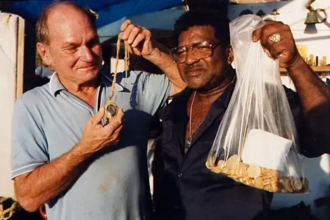 Harold Holden with chain and reliquary. Mo Molinar with 110 gold eight escudos (109 Lima, 1 Mexico), found on Gold Wreck near Douglas Beach, Ft. Pierce, Florida (1988).