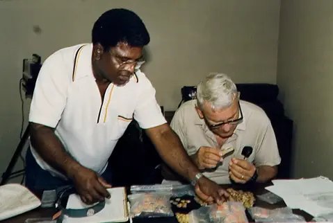 Mo Molinar and Lou Ullian inspecting gold coins from the 1988 season. These coins were found on the Gold Wreck near Douglas Beach, Ft. Pierce, Florida. Total haul 821 gold coins plus jewelry, 1988.