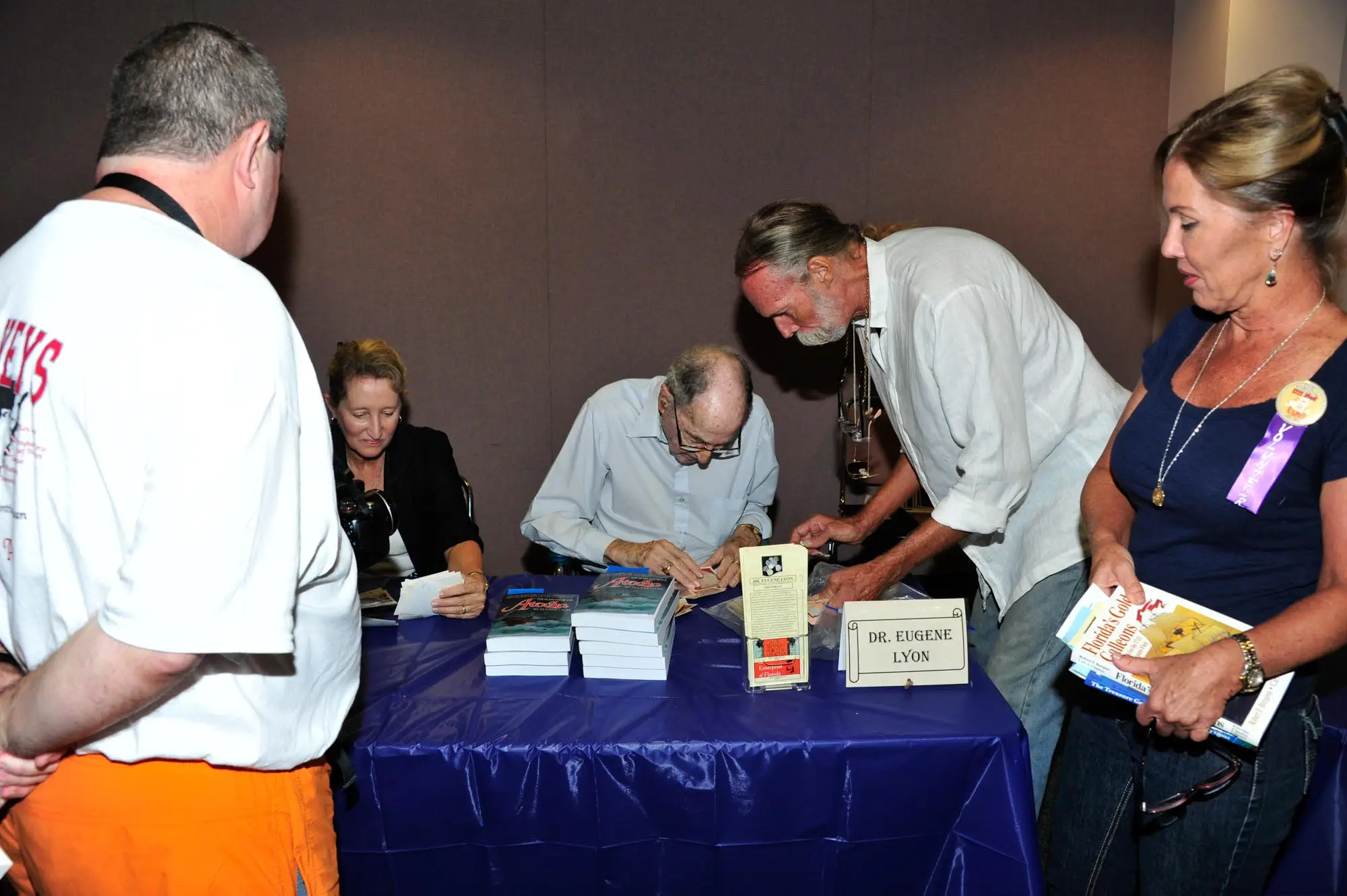 Dr Eugene Lyon Examining Photos presented to him by an attendee