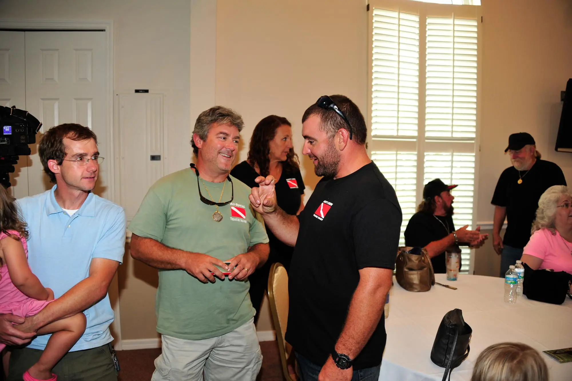 Eric Schmitt (Finder of the 1715 Tricentennial Royal) discusses his find with friends in attendance