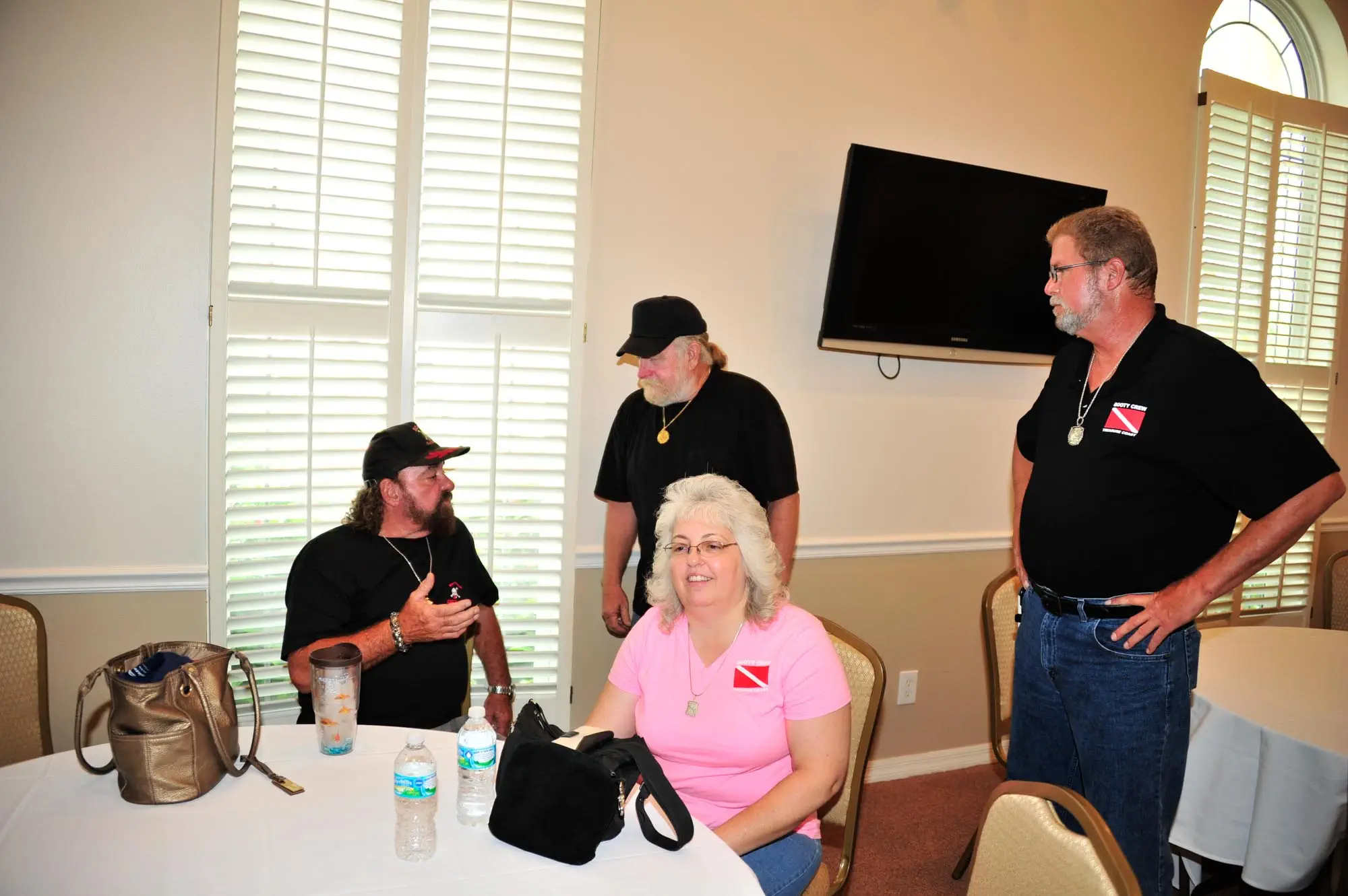 John Brandon (center) converses with Rick Schmitt about the Schmitt Family